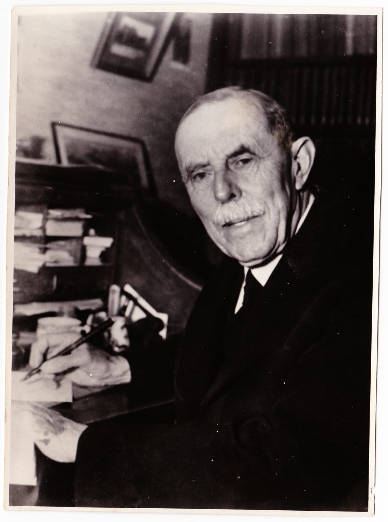 The last known photo taken of Dr. F.W. Boreham. Here he is sitting at his roll-top desk, with his trusty fountain pen in hand.